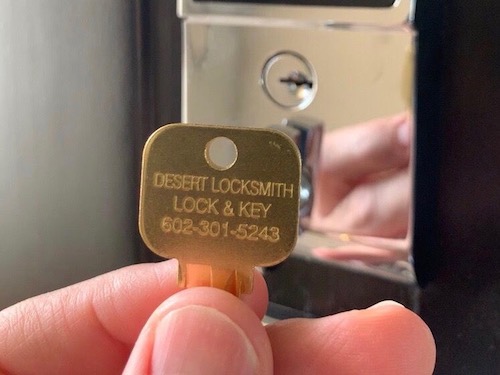 desert locksmith 602-301-5243 holding a key
