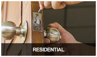 Image of a locksmith installing a residential lock on a front door.